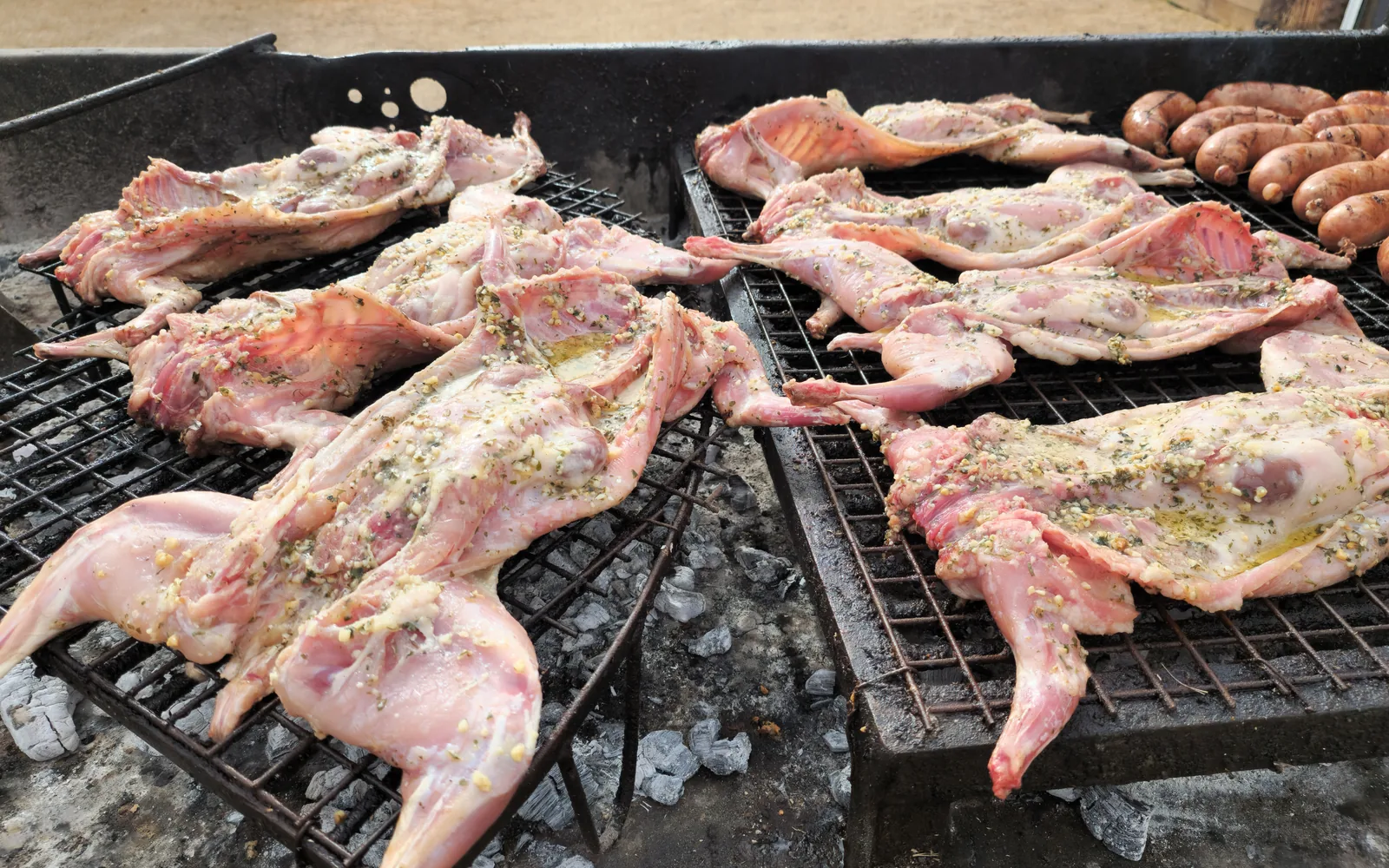 Conejos abiertos y condimentados sobre la parrilla